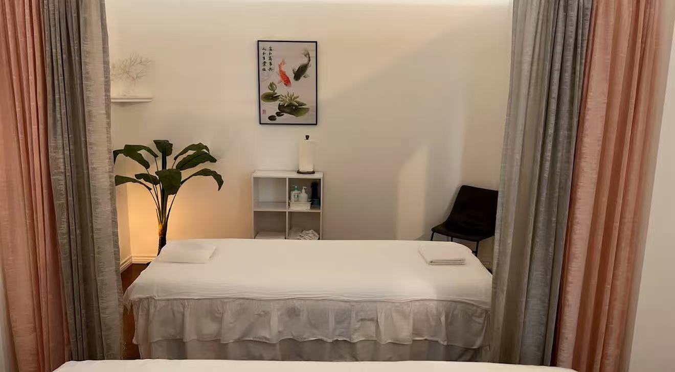 Private massage room with clean bed